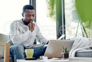 Finance, stress and worried black man paying bills on a laptop while doing paperwork at home. Concerned, anxious male checking budget, getting bad news or negative feedback of a rejected loan or debt