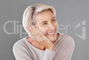 Thinking, idea and memory with a senior woman resting her head or chin on her hand in studio on a grey background. Skincare, health and beauty with a female looking to wellness and lifestyle