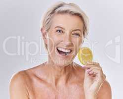 Skincare, health and face of senior lady with a healthy lifestyle holding an organic lemon. Portrait of a happy mature female with wrinkles doing a fresh citrus fruit body care wellness routine.