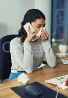 Hi, Id like to see the doctor...a young businesswoman blowing her nose while speaking on a cellphone in an office.