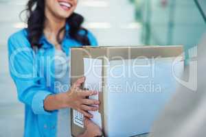 Well deliver direct to your door. a young woman receiving a package from the courier.