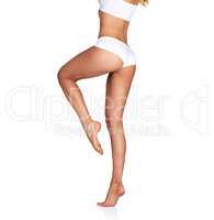 Beautifully balanced. Studio shot of an unrecognizable young woman in her underwear posing against a white background.