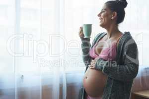 Maternity leave is great. an attractive young pregnant woman standing in her bedroom at home.