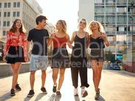 Travelling the city by foot. Full length shot of a group of young friends taking a walk through the city.