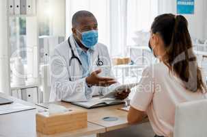 Doctors office, masks and sick patient consulting healthcare medic for covid virus test results at a hospital desk. Life insurance, people and medical employee giving woman support, help and service