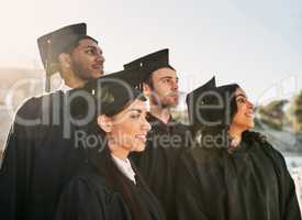 This accomplishment has inspired greatness in them all. a group of students standing together on graduation day.