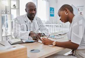 Woman writing, signature or sign on paper with a doctor at the hospital. Man healthcare professional consulting on medical insurance document or form. Discuss surgery compliance together in an office