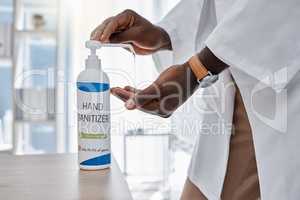 Covid, hand sanitizer and hygiene by doctor, healthcare worker and medical professional in clinic, hospital and wellness center. Closeup of consulting man cleaning virus, bacteria and germs off hands