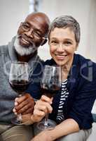I guess theyre ageing just like wine. an affectionate senior couple enjoying some wine together at home.