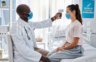 Temperature, thermometer and covid routine with doctor, medical professional and healthcare worker in clinic, hospital or wellness center. Woman or patient with mask checking fever to prevent disease