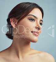 Give your skin an incredible boost. Studio shot of a young woman against a grey background.
