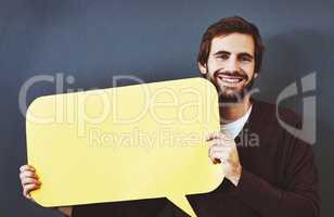 Get your thoughts out there for everyone to see. Studio portrait of a young man holding a speech bubble against a grey background.