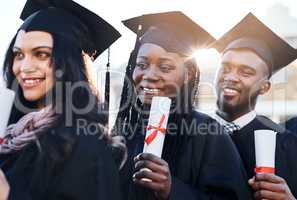 You only fail when you stop trying. Portrait of a group of students standing in a line on graduation day.