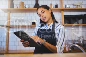 Cafe manager, planning online customer orders and working on digital tablet with internet, phone call and sales in restaurant startup. Small business owner, woman entrepreneur and hospitality worker