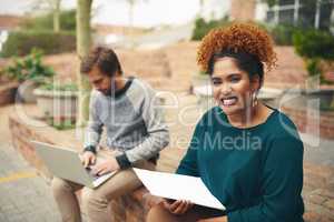 Exams are approaching and Ill be ready. High angle shot of two young university students studying on their campus grounds.