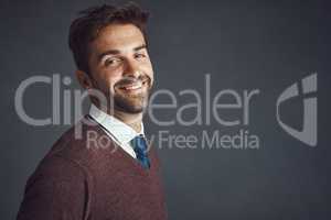 Mr Good Looking himself. Studio portrait of a stylishly dressed young man posing against a gray background.