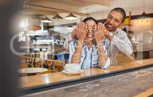 Wow, surprise and romantic boyfriend covering his girlfriends eyes for a present at a restaurant, coffee shop or cafe store. A happy birthday gift to celebrate their love, couple and woman together