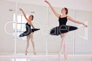 Ballet dancer or ballerina in dance studio practice or training for dancing performance or competition. Elegant, flexible and beautiful young woman in tutu practicing balance and flexibility