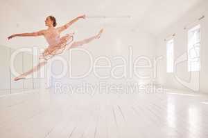 Ballet, dance and jumping in studio with classy performance and agility. Fit and beautiful ballerina moving in room with elegant energy. Dancing woman with style, grace and flexibility in her motion.