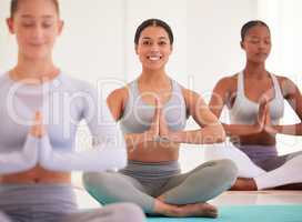 Yoga, wellness woman with namaste hands, prayer sign or Anjali mudra pose on mat in class for a healthy lifestyle. Spiritual people praying, meditating on floor in a health, zen or meditation studio