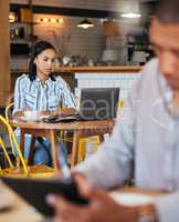 Working, reading and typing in a coffee shop with a digital worker writing an email on a computer. Job, career focus of a woman startup entrepreneur or digital web writer in a cafe or restaurant