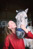 Feel like going for a ride. a teenage girl bonding with her horse.