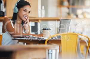 Creative woman in coffee shop with headphones listening to music, watching online social media on laptop or planning digital seo strategy. Remote graphic designer busy video editing at Internet cafe