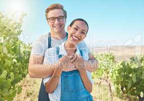 In love, countryside and farmer couple enjoying grape vine plant growth development in summer with flare or sunlight and blue sky. Happy, young rustic people hugging on a sustainable farm or vineyard
