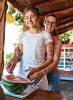 Theres a technique to slicing watermelon. Cropped portrait of a mother and daughter working at a farm stall.