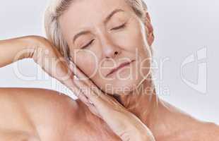 Skincare, beauty and wellness with health, skin and face of a senior woman in a studio on a purple background. Relax, spa and skin care with an elderly, calm model feeling healthy, happy and natural