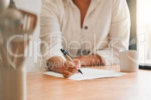 Writing, paperwork and contract with a woman holding a pen and filling out an application form in her kitchen at home. Insurance, tax and accounting while managing finance and the household budget