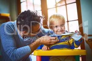 Theres always time for some tickles. a single father tickling his son at home.