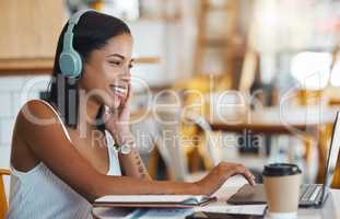 Happy student relaxing, studying or searching online videos on her laptop at a coffee shop with free internet. Young woman at a cafe store listening to music, radio or podcast news entertainment