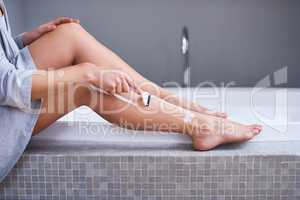 Smooth legs are a must. Closeup shot of an unrecognizable woman shaving her legs in the bathroom at home.
