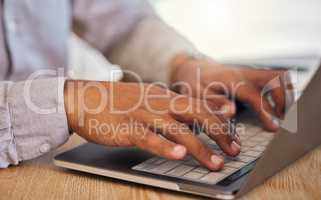 Closeup of a businessmans hands typing on laptop at work in corporate, creative and modern office. Professional male leader browsing the internet or coding on an innovative computer network.