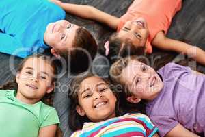 Happy friendship day. High angle portrait of a diverse group of kids lying together on the floor.