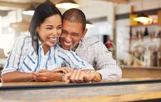 Couple laughing at funny joke at restaurant, boyfriend and girlfriend bonding with smile on romantic date and celebrating anniversary at coffee shop. Husband and wife showing love, having fun at cafe