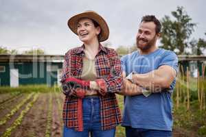Sustainability, agriculture and farmer couple on a farm growing vegetable crops, enjoying a clean eco friendly environment. Happy rustic people, man and woman with vision for sustainable development