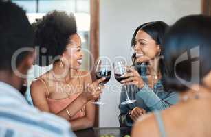 Friends having fun and drinking wine, toasting, bonding and celebrating at an event or party. Diverse friends cheers and laughing, enjoying free time, dining experience and wine tasting gathering