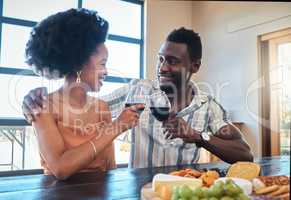 Celebration, love and black couple toasting with wine on a romantic date indoors, bonding and flirting. Lovers happy, in love and carefree, celebrating their anniversary and sharing intimate moment