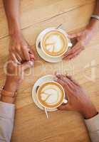 Coffee shop, dating and couple holding hands from top view at cafe. Married boyfriend and girlfriend touching each other while relaxing. Romantic, trust and in love people enjoy anniversary together.