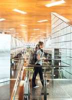 She knows where shes going. Full length shot of an attractive young woman walking through an airport.