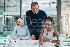 Architect, engineering blueprint and industrial designer working on building design, sketch plan and construction project. Diverse team of creative people in collaboration for property development