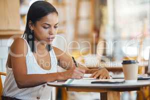 Small business owner, startup entrepreneur or cafe store manager writing notes, working on strategy or planning in a coffee shop. Professional, finance and budget businesswoman filling out papers.