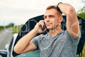 Help, Ive got a roadside emergency. a young man calling roadside assistance after breaking down.