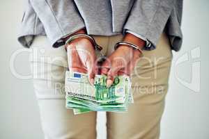 Corporate fraud, stealing or money laundering deal of a business woman with handcuffs and cash. Back hands view of legal justice of a caught white collar work employee going to court, jail or prison