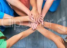 Winning as one. a group of kids joining their hands in solidarity.