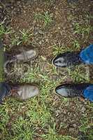 You have some big shoes to fill. two unrecognizable peoples shoes standing next to each other on a patch of grass outside during the day.