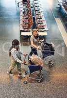 Headed to the luggage check-in. High angle shot of two attractive young women walking through an airport.