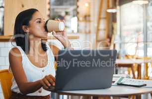 Entrepreneur drinking tea while working on laptop at cafe, woman reading emails online and person enjoying a remote work space at a restaurant. Thinking female browsing the internet at coffee shop